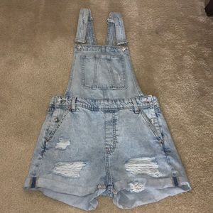 Distressed denim overalls